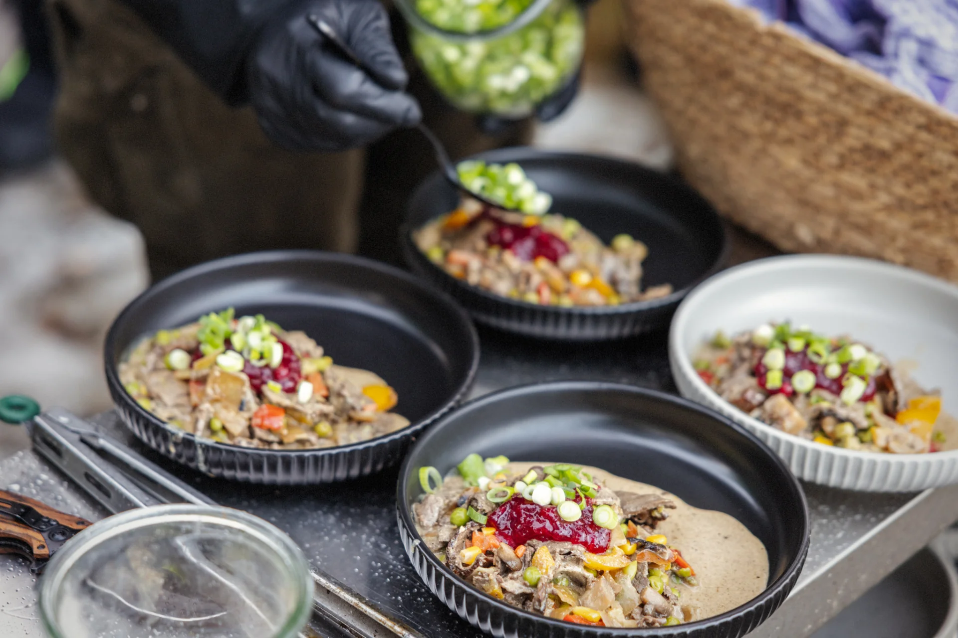 Reindeer stew bowls finished with lingonberry and spring onion