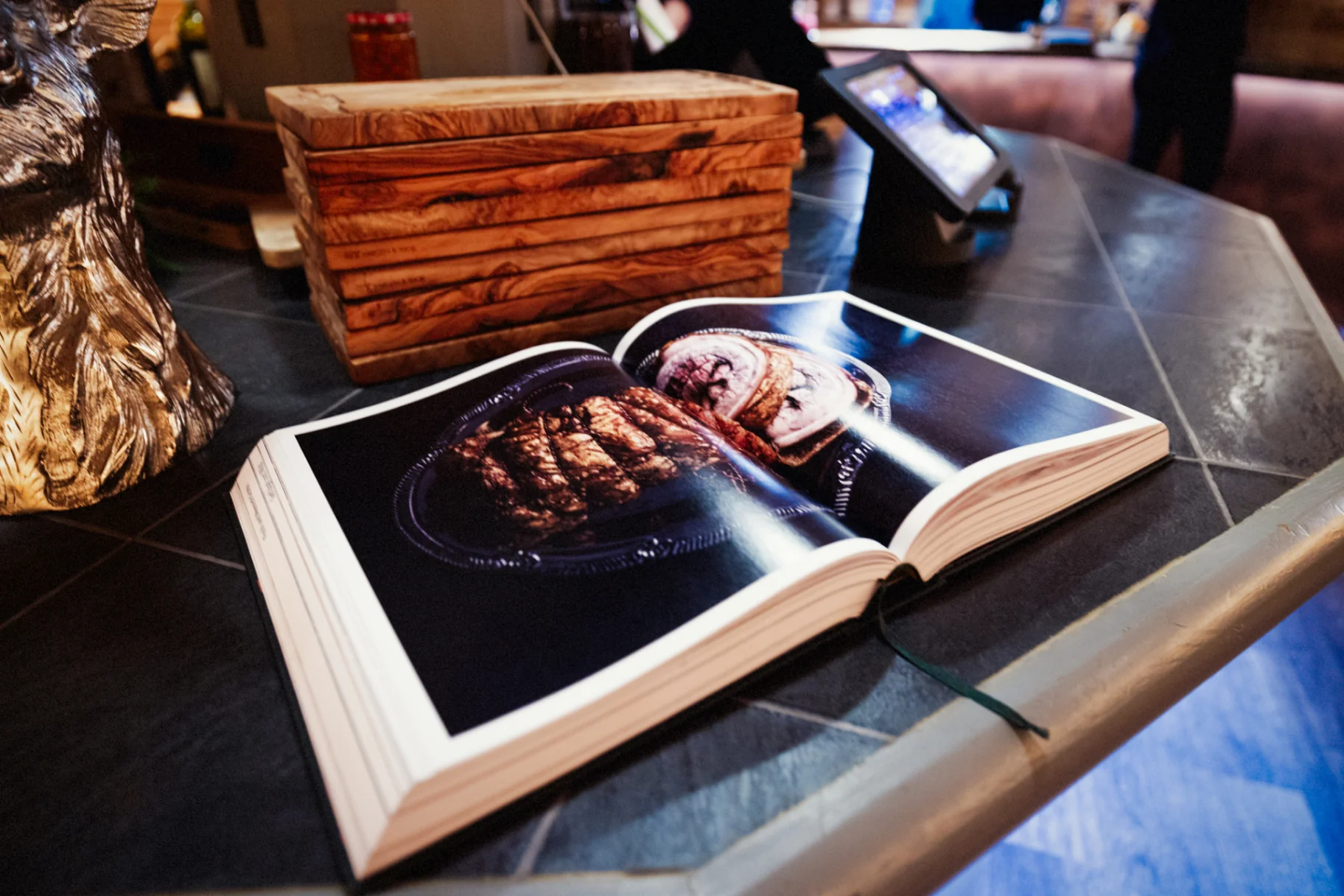 Open cookbook showing signature dishes at JayJay's