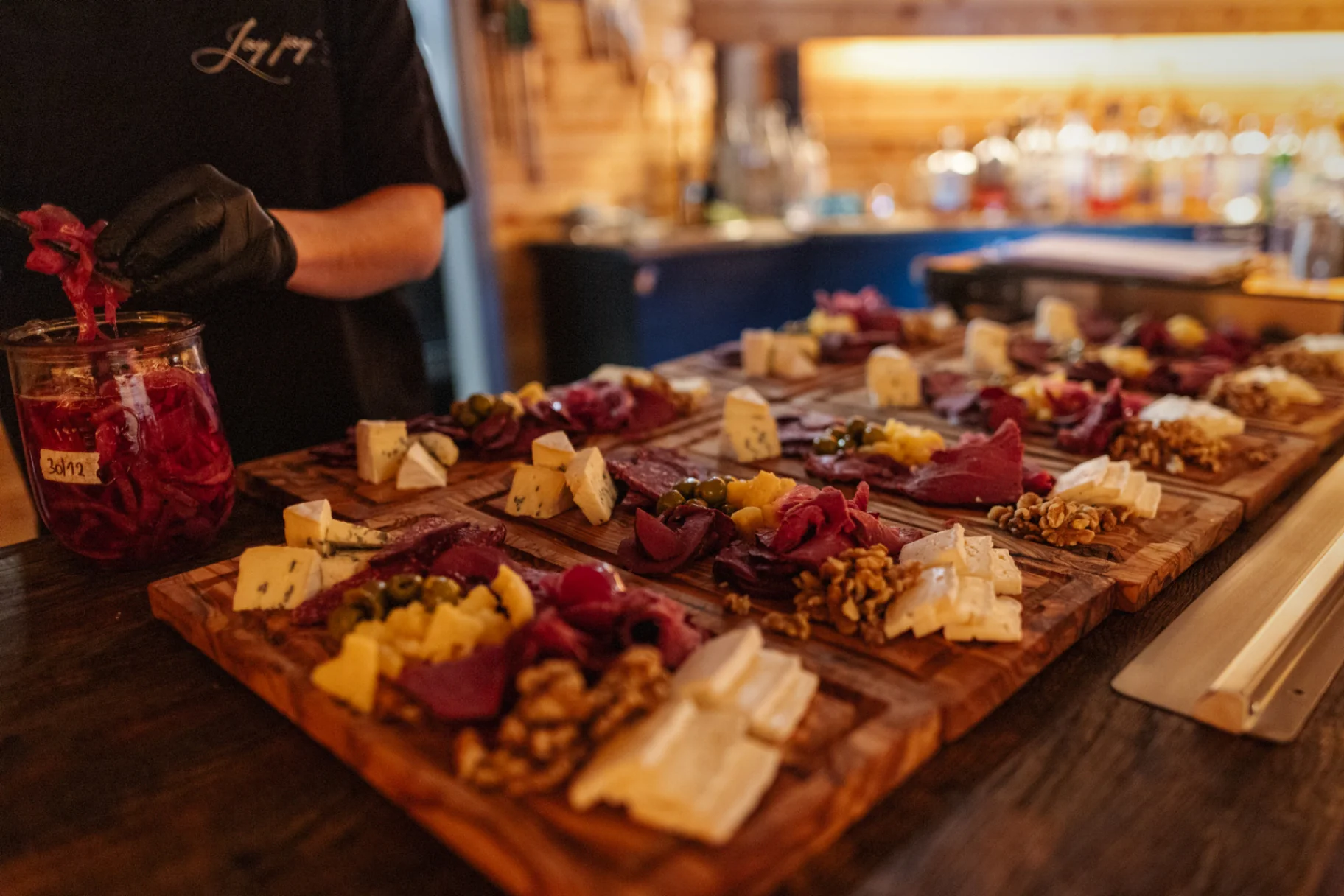House charcuterie and cheese boards with pickled onions and walnuts
